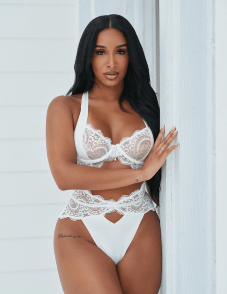 Front view of the First Class White Lace Bra & Thong Set featuring a white lace bra with unlined underwire cups, wide adjustable straps, crystal detail, and a matching high-waist lace thong.