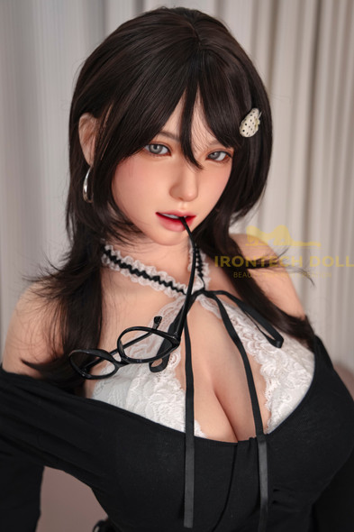 Close-up of IronTech Kitty silicone sex doll with long brunette hair, gray eyes, and black-and-white lace top.