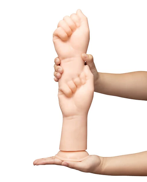 b-Vibe Fists 14.5 Inch Realistic XXL Dildo held in hand showing its large scale and realistic fist shape