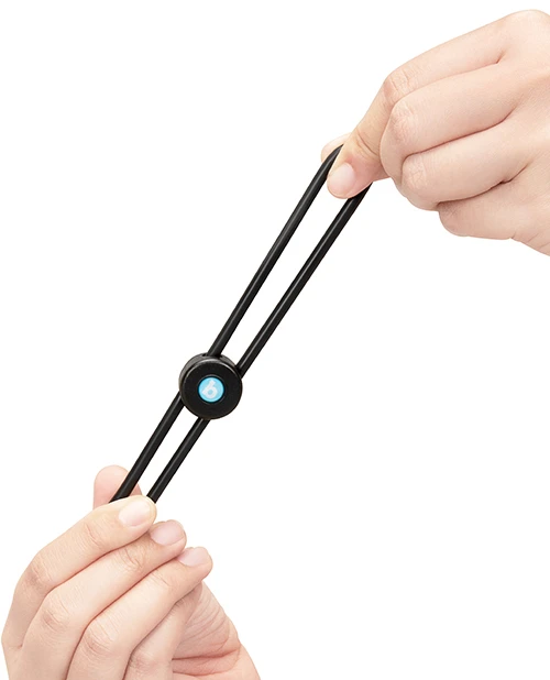 Hands stretching the flexible silicone loop of the b-Vibe Lasso Grip cock ring