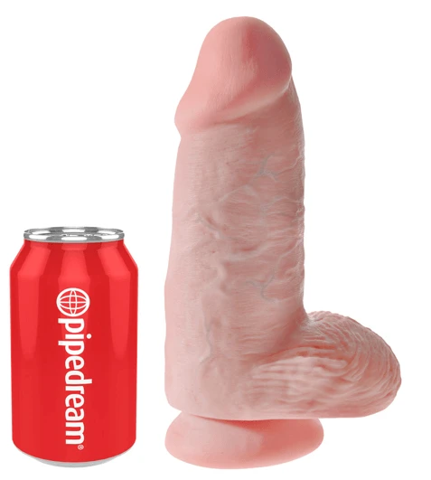 Realistic Chubby dildo with suction base shown next to can for scale