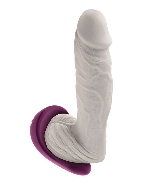 Gender X BJ Buddy shown supporting the testicles beneath a penis, demonstrating how the scooped design cradles and vibrates sensitive areas during partnered play.