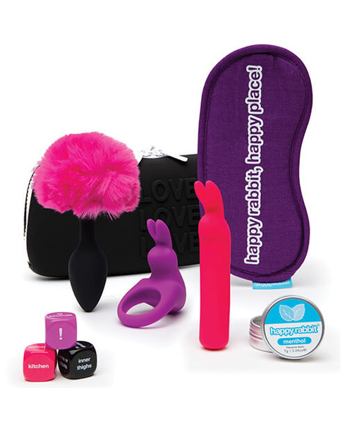 A travel pleasure kit with a mini vibrator, cock-ring, butt plug, and blindfold