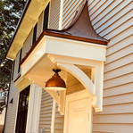 Cedar Bracket 10T10 — installed above front doors view | Timber Build