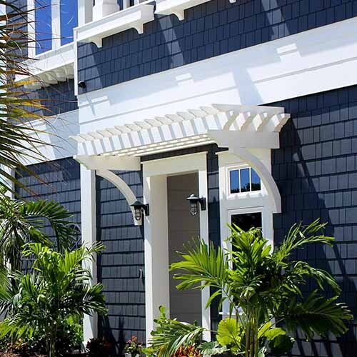 Coastal architectural design featuring dark blue shake siding