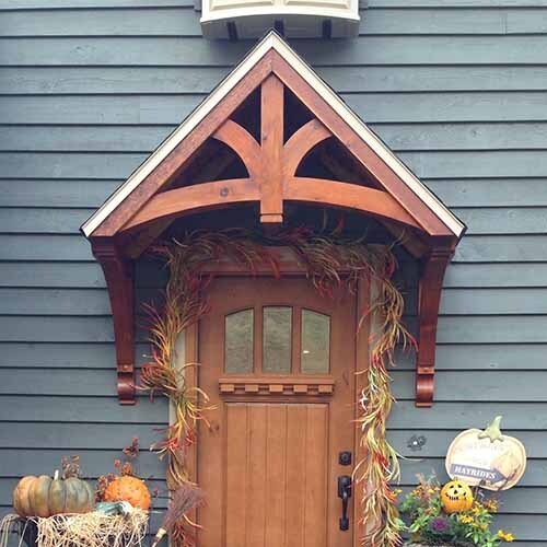 At the peak of the gable, there is a prominent vertical wooden element