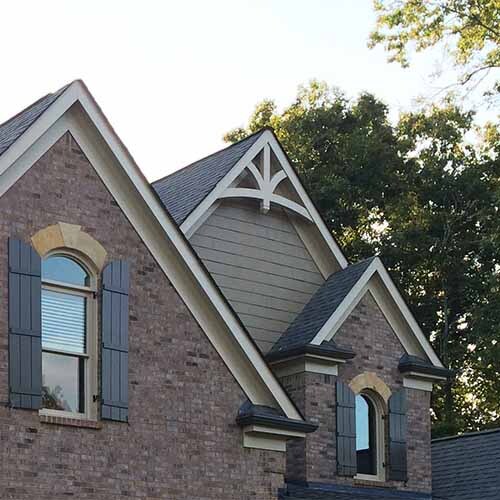 The house features multiple prominent gables, the triangular wall sections at the end of a pitched roof