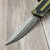 Close-up of Microtech Scarab II Gen III apocalyptic finish double edge serrated blade detail.