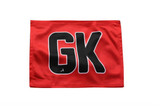 A red netball bib featuring the initials "GK" in large black letters. It includes a logo in the corner.