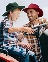 A navy slouch hat with a wide brim and a break-away clip attachment for secure wear. It features a drawstring for adjustments.
