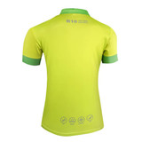 A vibrant yellow polo shirt with green accents, featuring a logo and various symbols on the back.