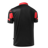 A men's polo shirt in black with red accents, featuring a sleek design and a collar. The shirt has a logo on it.