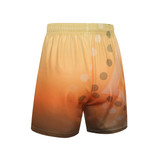 A pair of shorts featuring a gradient design in warm orange and brown tones, with circular patterns and a logo.