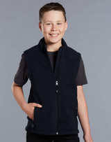 A boy wearing a navy blue fleece vest with a zip and side pockets, smiling against a grey background.