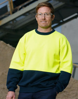 A Hi-Vis two tone safety windcheater in bright yellow and navy, worn by a man with safety glasses.