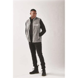 A men's grey Sherpa fleece vest with a front pocket, styled with a black long-sleeve shirt and trousers.