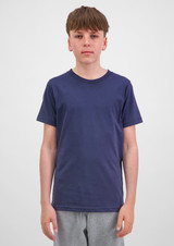 A youth short sleeve tee in navy blue, displayed on a model standing against a plain background, with a logo visible.