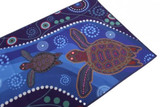 A vibrant spread towel featuring two turtles on a blue background with intricate patterns and designs.