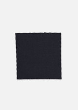 A square swatch of dark navy wool stretch suiting fabric with a textured finish and scalloped edges.
