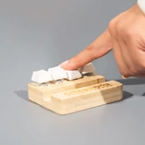 A bamboo stand holder with three white key-shaped buttons, designed for stress relief, featuring a logo.