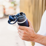 A drink bottle in navy blue with a grey lid and a built-in straw, featuring a logo on the side.