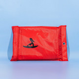 A red fiberglass emergency fire blanket packaged in a pouch, featuring a logo on the front.