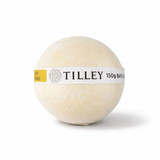 A bath bomb in a round shape, cream-coloured with a yellow label featuring branding.