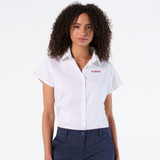 A white short sleeve button-up shirt with a collar and a logo on one side, styled on a model.