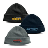 A trio of Seattle polar fleece beanies in grey, dark blue, and black, featuring various logos.