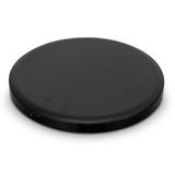 A round black wireless charger with a sleek design, featuring a USB port.