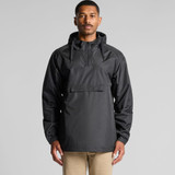A man wearing a black windbreaker jacket featuring a hood and front pocket. The jacket has a logo on it.