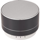 A round black aluminium Bluetooth speaker with a silver grille and control buttons on the base. It has a simple, modern design.