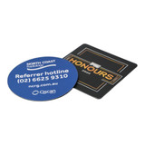 A round blue coaster and a square black coaster, both featuring logos and text.