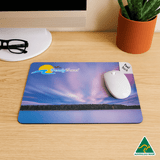 A mouse mat featuring a vibrant sunset design in shades of purple and blue, with a white mouse and a logo.