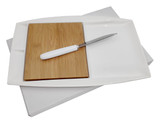 A white Jumbo Party Plate with a bamboo cutting board and a metal knife, set against a plain background.