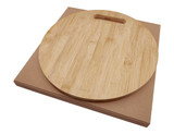 A round bamboo cheese board with a handle, resting on a brown kraft box.