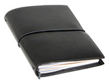 A black A5 journal with a flexible cover, featuring an elastic closure and visible pages. It has a logo on the front.