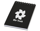 A black spiral notebook with a white logo and branding on the front cover.