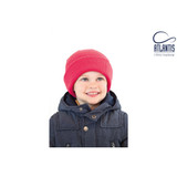 A red beanie for children worn by a smiling child in a navy blue jacket. The beanie features a logo.