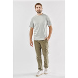 A man in a light grey T-shirt paired with khaki cargo pants, standing against a neutral background. The shirt has a logo.