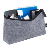 A grey zippered pouch containing a phone, charger, notebook, and various small items. It has a branding logo.