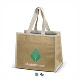 A jute cooler bag in natural brown with light beige handles and an interior for insulation. Features a logo.