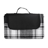 A picnic rug featuring a black and white checkered pattern, neatly folded with a handle for easy transport.