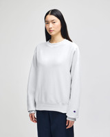 A light grey adult crew sweatshirt with a relaxed fit, featuring a logo on the sleeve.
