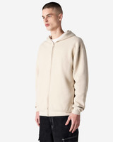 A unisex full zip hooded sweatshirt in a light beige colour, featuring a hood and a zip closure, shown on a model.