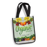 A tote bag in green and black with a vibrant fruit and vegetable design and a logo on the front.