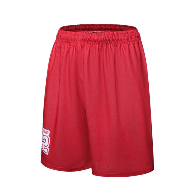 A pair of red women's basketball uniform shorts featuring an elastic waistband and a logo on the side.