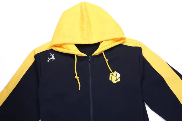 A navy and yellow fleece hoodie featuring a hood and a logo on the chest.