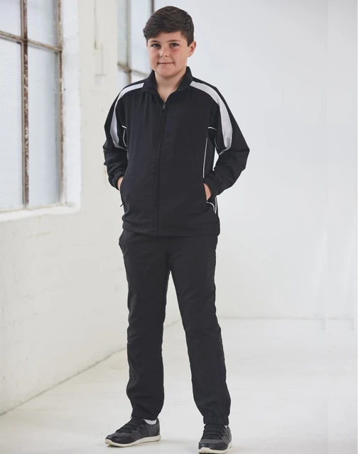 A black track jacket with white accents, featuring a zip front and side pockets, modelled by a young boy.