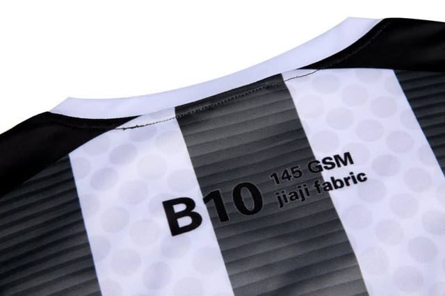 A black and white jersey featuring a striped design and a label indicating fabric type and GSM.